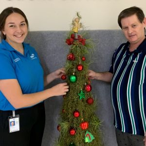 School-based trainee Lilyana van Twest and Matthew Jarvis decorate the Christmas tree