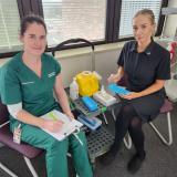 Katelyn Verrall (left) gets ready for her flu jab delivered by Infection Prevention Clinical Nurse Georgia Naden (right)